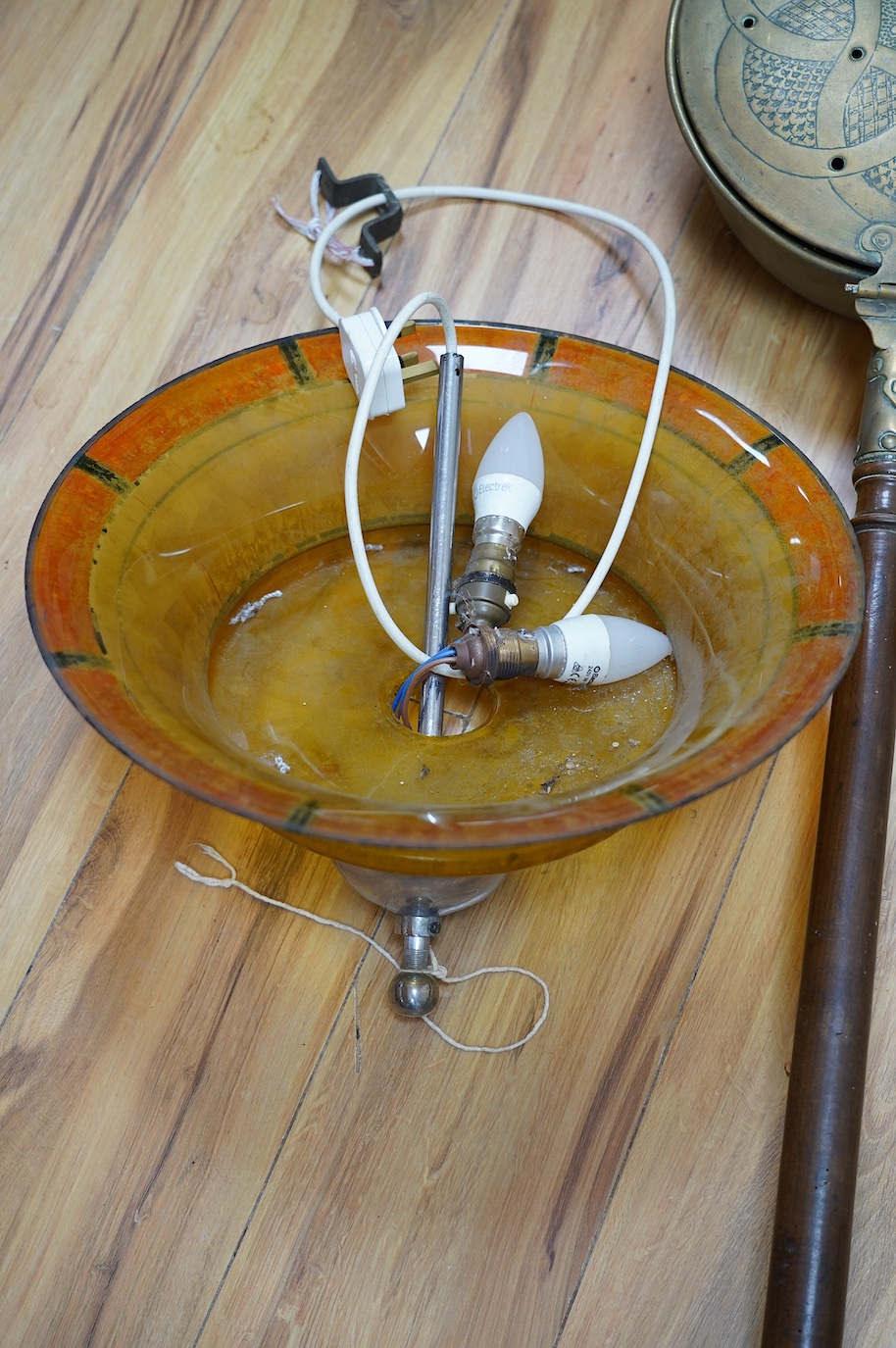 An Art Deco glass light shade, 40cm diameter, and an embossed brass warming pan, 194cm long. Condition - poor to fair